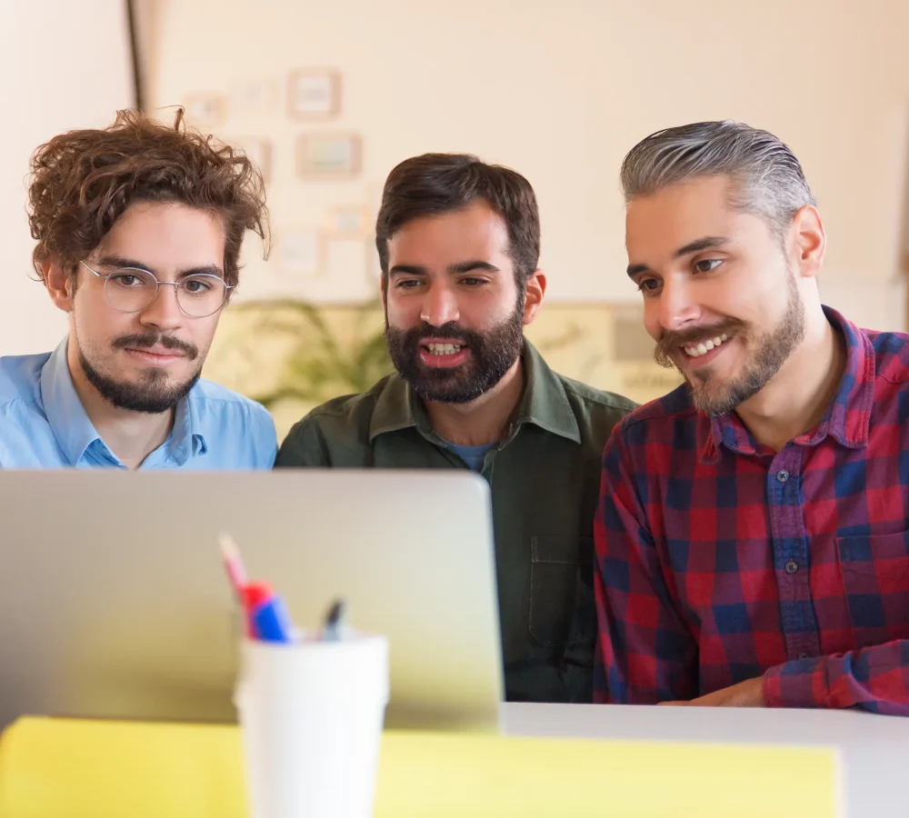 happy-startup-team-watching-presentation-monitor